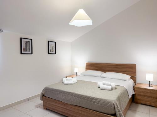 a bedroom with a large bed and two night stands at Guest House Maramà in Belvedere Marittimo