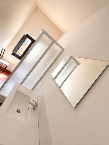 a bathroom with a sink and a mirror at La casa del Borgo in Cetraro