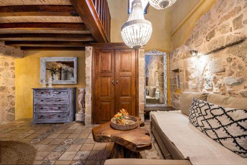 a living room with a couch and a stone wall at George & Alexandra's Apartments in Rhodes Town