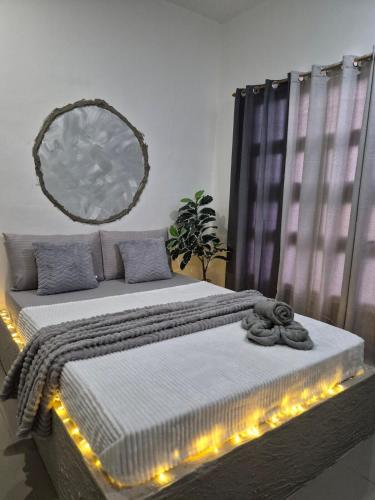 a bedroom with a bed with lights on it at The Lake Haus Cebu in Lapu Lapu City