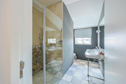 a bathroom with a glass shower and a sink at Solar de Arrayollos by PURUS in Arraiolos
