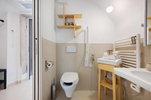 a bathroom with a white toilet and a sink at Agriturismo Cascina Capo in Negrar