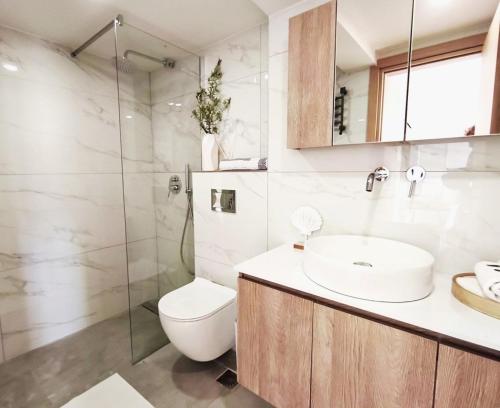 a bathroom with a sink and a toilet and a shower at Dorian in Kos