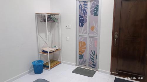 a room with a door and a room with a shower at AZ Guest House & Inn in Pasir Mas