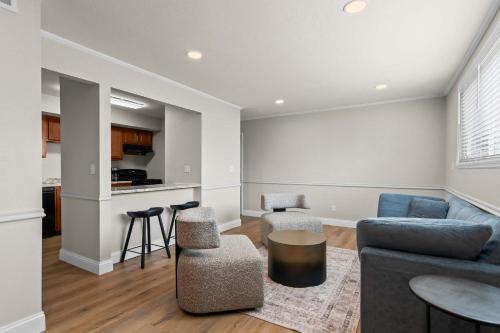 a living room with a couch and a table at Newly Renovated Unit in Central Spfld #101 in Springfield