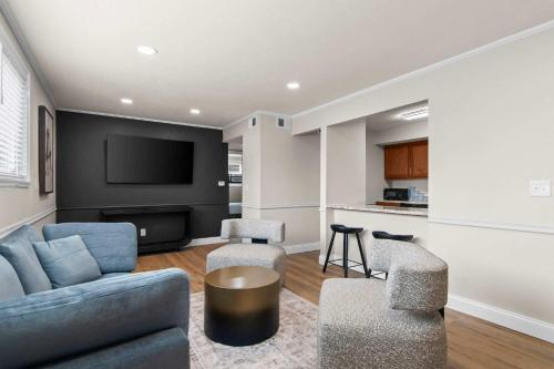 a living room with a couch and a tv at Newly Renovated Unit in Central Spfld #101 in Springfield