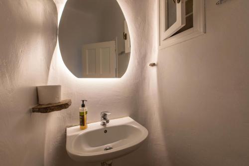 a bathroom with a sink and a mirror at Evagelia's Place in Agios Ioannis Mykonos