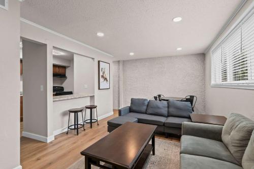 a living room with a couch and a table at Newly Renovated Unit in Central Spfld #103 in Springfield