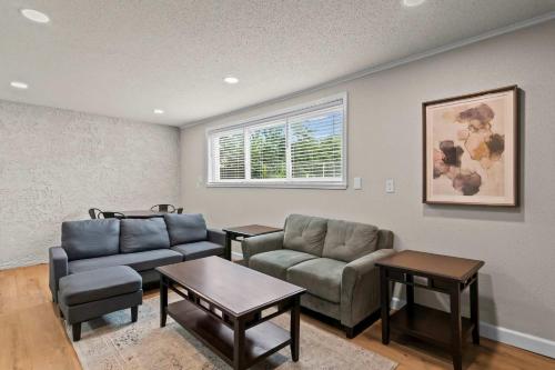 a living room with a couch and a table at Newly Renovated Unit in Central Spfld #103 in Springfield