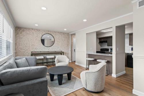 a living room with a couch and chairs and a table at Newly Renovated Unit in Central Spfld #204 in Springfield