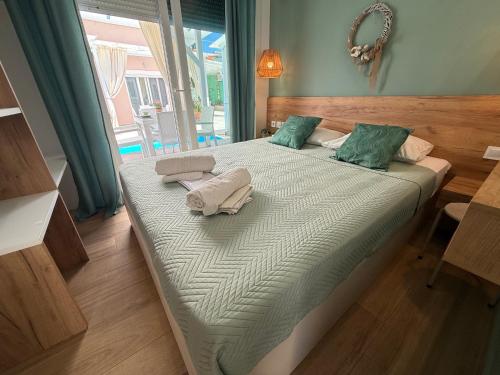 a bedroom with a bed with two towels on it at ΑVLI Superior Studio Sarti no6 in Sarti