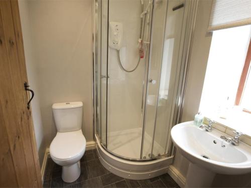 a bathroom with a shower and a toilet and a sink at 1 Bed in Ripon oc-g0023 in Winksley