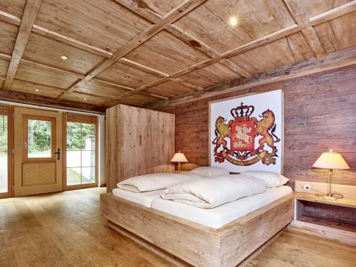 a bedroom with a large bed in a room with wooden walls at Emmat Apartments in Leutasch