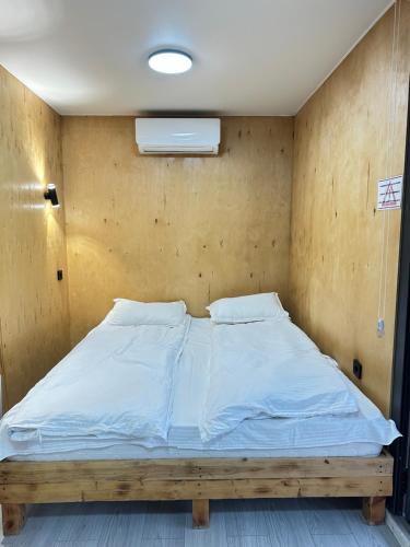 a bed with white sheets and pillows in a room at Пан0рама in Saty