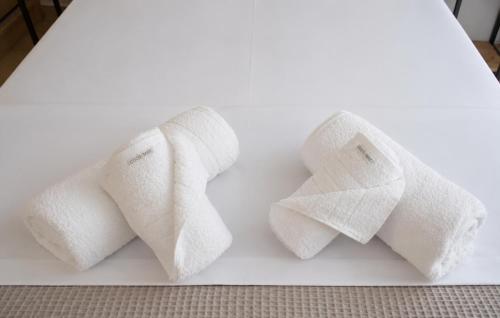 three rolls of toilet paper on a white table at Emmeleia Urban Apartment in Xanthi