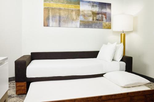 two beds in a hotel room with a couch at SpringHill Suites by Marriott Chesterfield in Chesterfield
