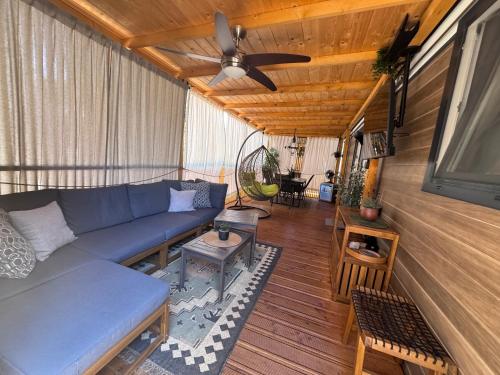 a living room with a couch and a ceiling fan at Mobile home FJAKA in Biograd na Moru