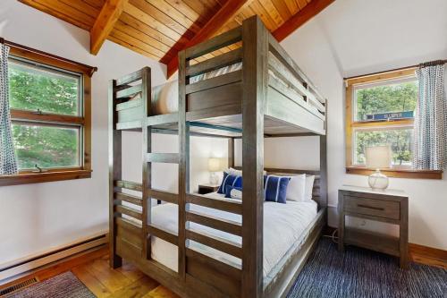 a bedroom with a bunk bed and two windows at Lincoln Gap Retreat in Warren