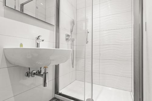 a bathroom with a sink and a shower at Villa Manuela in Opatija