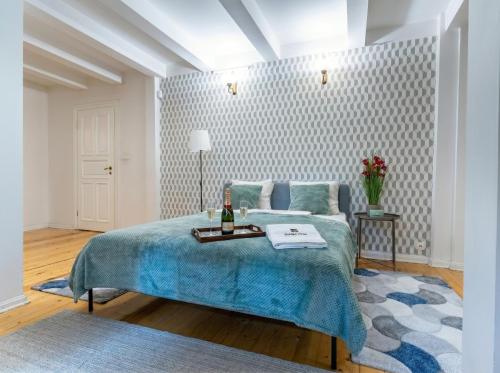 a bedroom with a bed with a bottle of wine on it at Golden Villas Luxury Garden Retreat - Jacuzzi & Sauna in Konstancin-Jeziorna