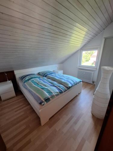 a bedroom with a bed with a wooden ceiling at Ferienchalet Hechingen in Hechingen