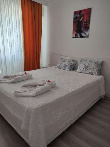 a bed with white sheets and towels on it at Umut's Hause in Bezkesen
