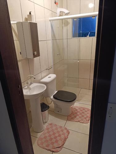 a bathroom with a toilet and a sink at Casa indaial in Indaial