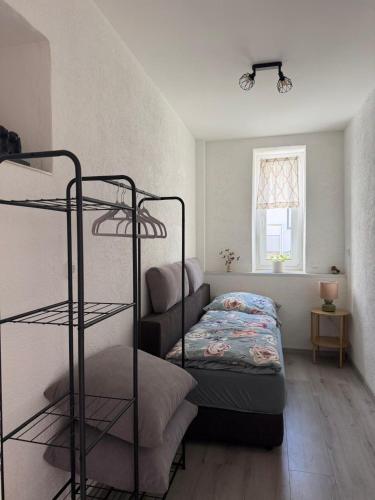 a bedroom with a bunk bed and a bed and a couch at Dianas Ferienwohnung 1 in Feldberg