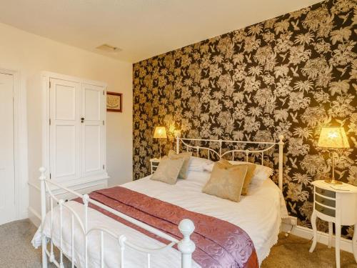 a bedroom with a bed with a floral wallpaper at 1 Bed in York oc-91888 in Full Sutton