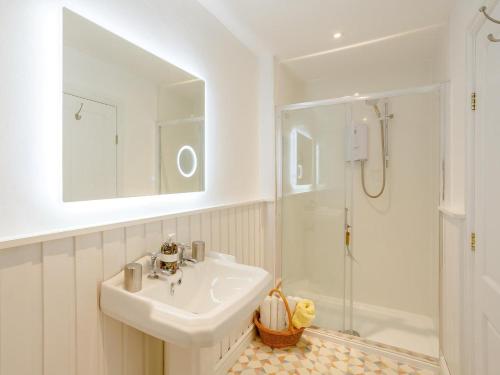 a white bathroom with a sink and a shower at 1 Bed in York oc-91888 in Full Sutton