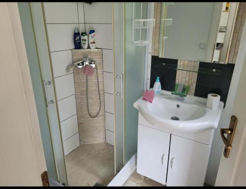 a small bathroom with a sink and a shower at Holiday home Samir in Jajce