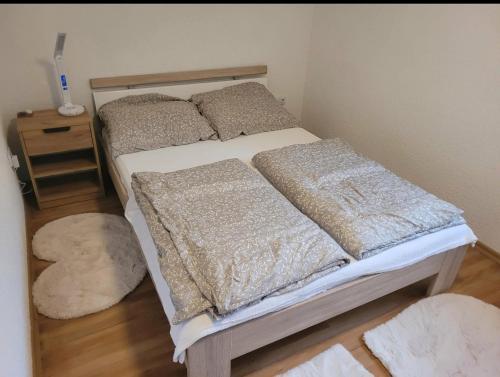 a bedroom with a bed with pillows and a night stand at Holiday home Samir in Jajce