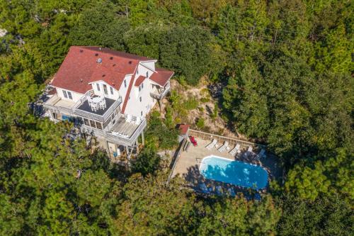 an aerial view of a large house with a swimming pool at Carotank Clubhouse - Corolla Village, 200 Yds to Beach, Foosball, Pool, Hot Tub, Flex Stays in Corolla