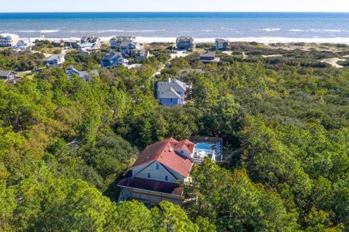 an aerial view of a house in the trees near the ocean at Carotank Clubhouse - Corolla Village, 200 Yds to Beach, Foosball, Pool, Hot Tub, Flex Stays in Corolla