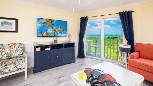 a living room with a view of the ocean at Sunrise Penthouse 3316 Ocean Pointe 1BR 2BA in Tavernier