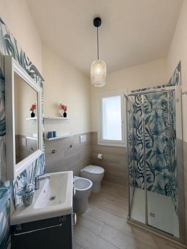 a bathroom with a shower and a toilet and a sink at Modern Sea Apartment in Punta Marina