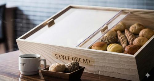 a box of different types of donuts and a cup of coffee at Nesthotel Alt Meguro Ekimae in Tokyo