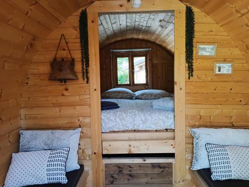 a room in a log cabin with a bed in it at Lagarta , la buche in Étival