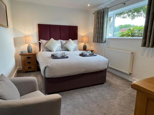a bedroom with a bed and a chair and a window at 1 Bed in Wells oc-88969 in Wells