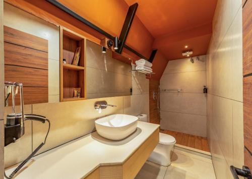 a bathroom with a sink and a toilet at Cliff and Cloud Vagamon in Vagamon