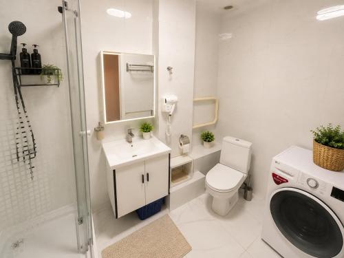 a bathroom with a toilet and a sink and a shower at LG53 Tour & Hostel in Ulaanbaatar