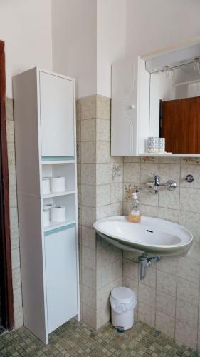 a bathroom with a sink and a white cabinet at Gacka idila in Otočac