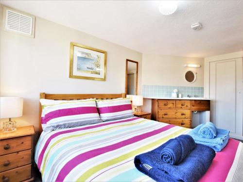 a bedroom with a bed with blue towels on it at 1 Bed in Swanage oc-dc098 in Swanage