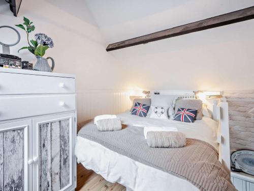 a bedroom with a white bed with pillows on it at 1 Bed in Lymington oc-94751 in Lymington