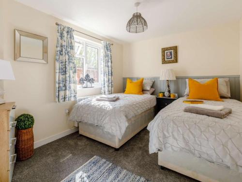a bedroom with two beds and a window at 2 Bed in Ashbourne oc-81345 in Clifton