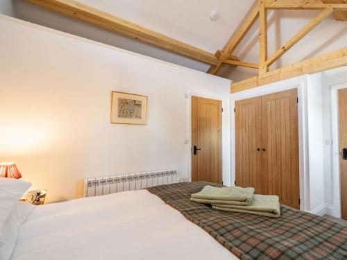 a bedroom with a bed with towels on it at 1 Bed in Carnforth oc-90554 in Middleton