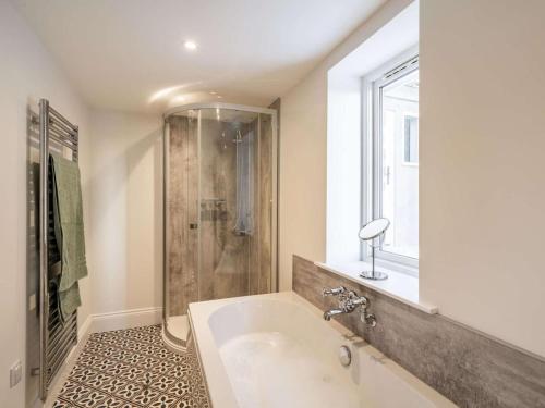 a bathroom with a tub and a shower and a sink at 1 Bed in Carnforth oc-90554 in Middleton