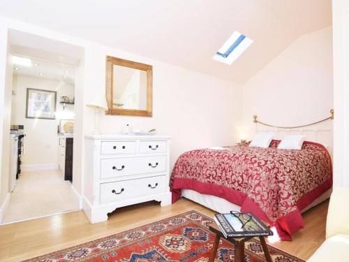 a bedroom with a bed and a dresser and a mirror at 1 Bed in Riding Mill oc-cn063 in Corbridge