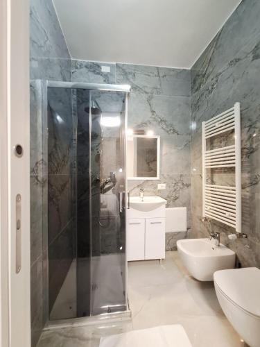 a bathroom with a shower and a toilet and a sink at Hotel Solferino in Brescia
