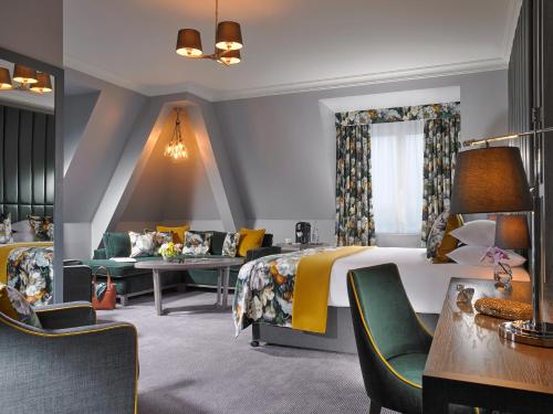 a hotel room with two beds and a table at Carrigaline Court Hotel & Leisure Centre in Cork